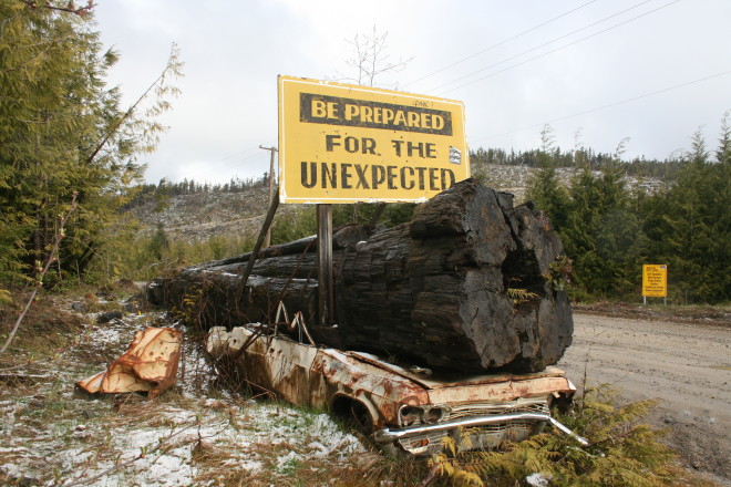On the logging road to Holberg. The sign to the right lists hazards and ends with "good luck"!