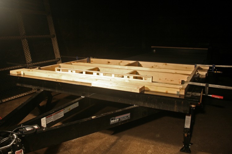 Using clamps to hold the blocking in place so holes can be drilled to attach it to the trailer