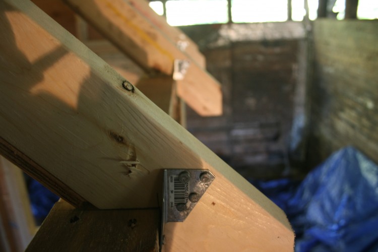 Hurricane ties securing each rafters to the wall